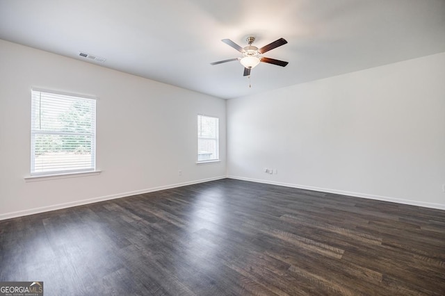 180 Oliver Dr, Locust Grove, GA 30248 - empty room with ceiling fan, dark wood-style floors, and baseboards
