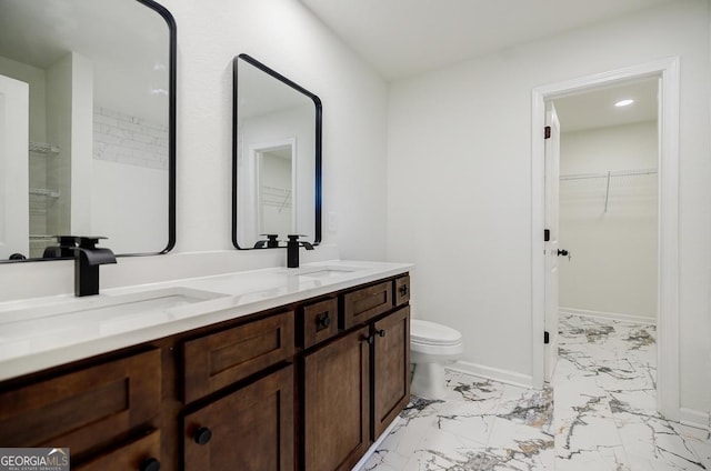 180 Oliver Dr, Locust Grove, GA 30248 - bathroom featuring marble look tiles, toilet, double vanity, a walk in closet, and baseboards