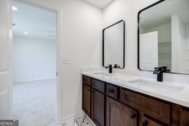 180 Oliver Dr, Locust Grove, GA 30248 - bathroom featuring baseboards and double vanity