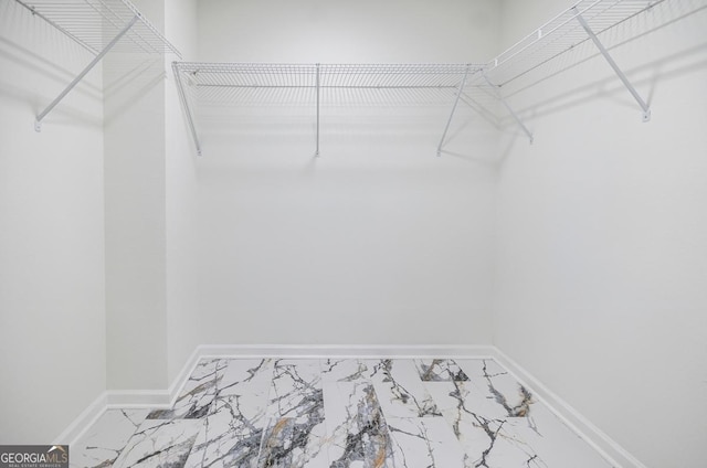 180 Oliver Dr, Locust Grove, GA 30248 - walk in closet with marble look tile flooring