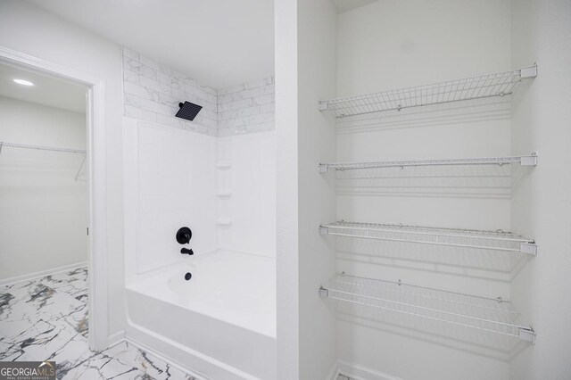 180 Oliver Dr, Locust Grove, GA 30248 - full bath with marble finish flooring, a spacious closet,  shower combination, and baseboards