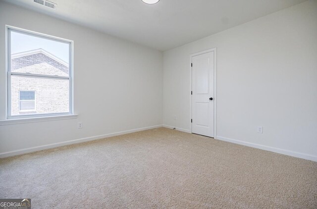 180 Oliver Dr, Locust Grove, GA 30248 - empty room featuring light carpet and baseboards