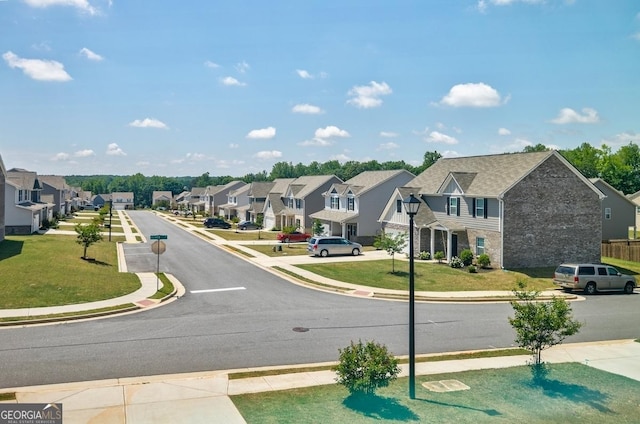 180 Oliver Dr, Locust Grove, GA 30248 - view of asphalt street featuring a residential view, sidewalks, and curbs