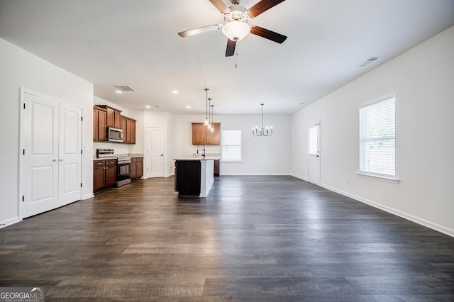 180 Oliver Dr, Locust Grove, GA 30248 - unfurnished living room with a chandelier, ceiling fan, baseboards, dark wood finished floors, and recessed lighting
