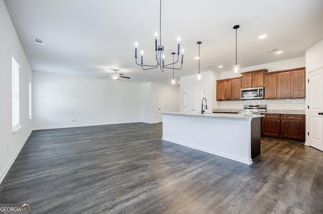 180 Oliver Dr, Locust Grove, GA 30248 - kitchen featuring stainless steel appliances, a chandelier, tasteful backsplash, dark wood-type flooring, and recessed lighting