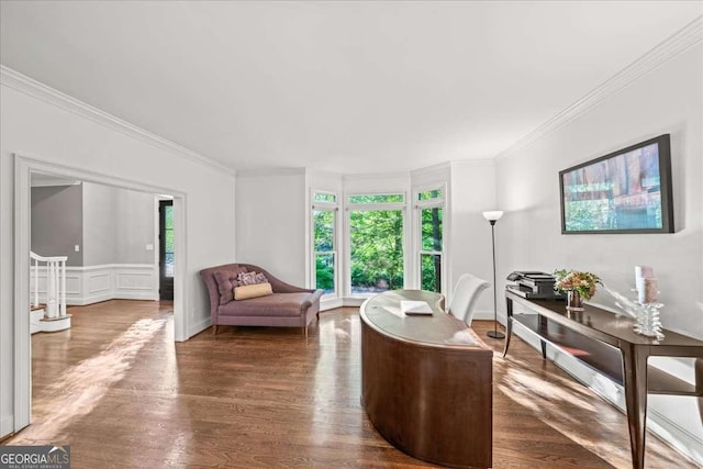 living area with crown molding and wood finished floors