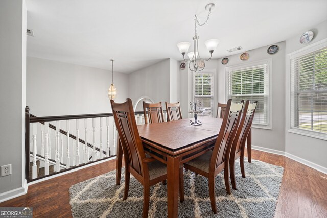 59 Kaiser Ct, Dallas, GA 30132 - dining space with healthy amount of natural light, a chandelier, baseboards, and wood finished floors