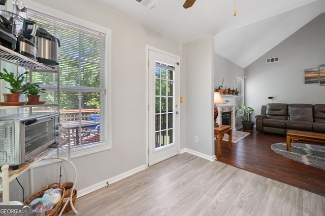 59 Kaiser Ct, Dallas, GA 30132 - living room featuring wood finished floors, a fireplace with flush hearth, a ceiling fan, baseboards, and vaulted ceiling