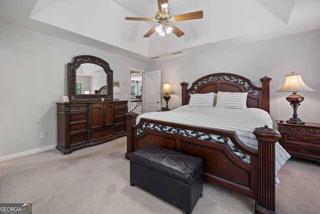 59 Kaiser Ct, Dallas, GA 30132 - bedroom with a tray ceiling, light carpet, baseboards, and ceiling fan