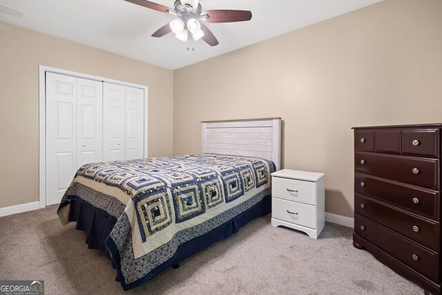 59 Kaiser Ct, Dallas, GA 30132 - bedroom with light colored carpet, a closet, baseboards, and a ceiling fan