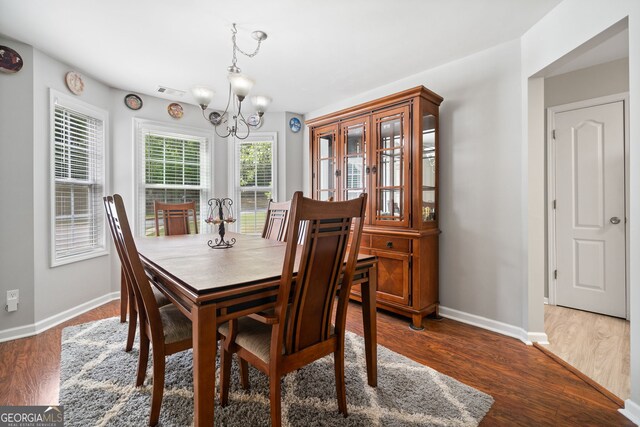 59 Kaiser Ct, Dallas, GA 30132 - dining space with a chandelier, baseboards, and wood finished floors