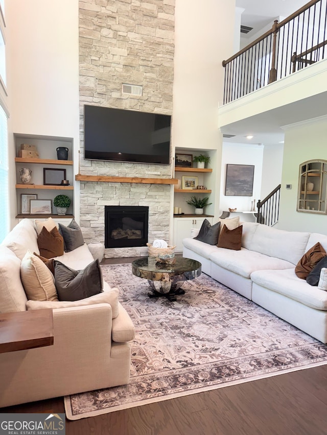 4736 Landing Water Path, Buford, GA 30519 - living room featuring a towering ceiling, wood finished floors, and a fireplace
