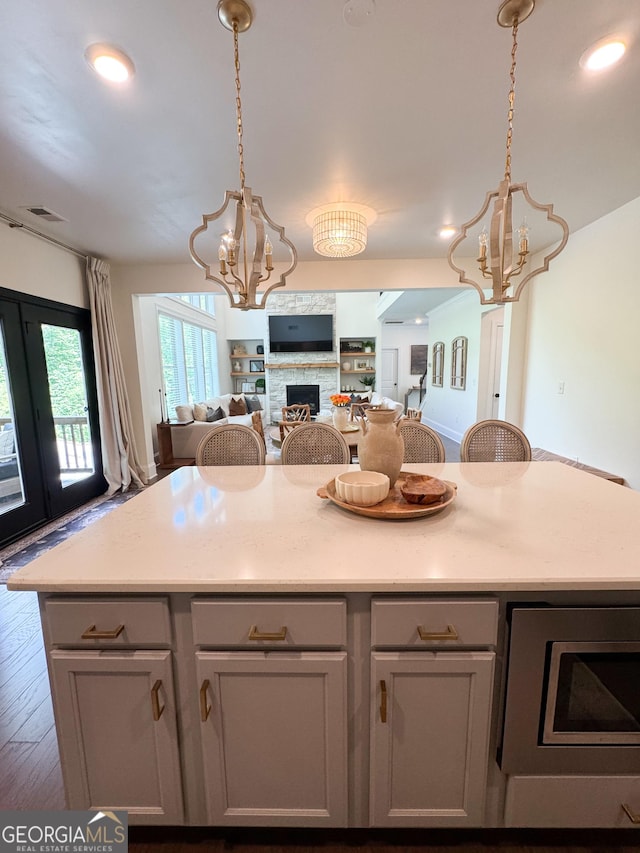 4736 Landing Water Path, Buford, GA 30519 - kitchen with a chandelier, open floor plan, a center island, light countertops, and recessed lighting