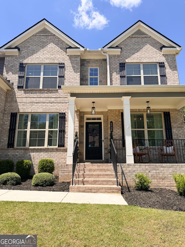 4736 Landing Water Path, Buford, GA 30519 - view of front of home with brick siding, covered porch, and a front lawn