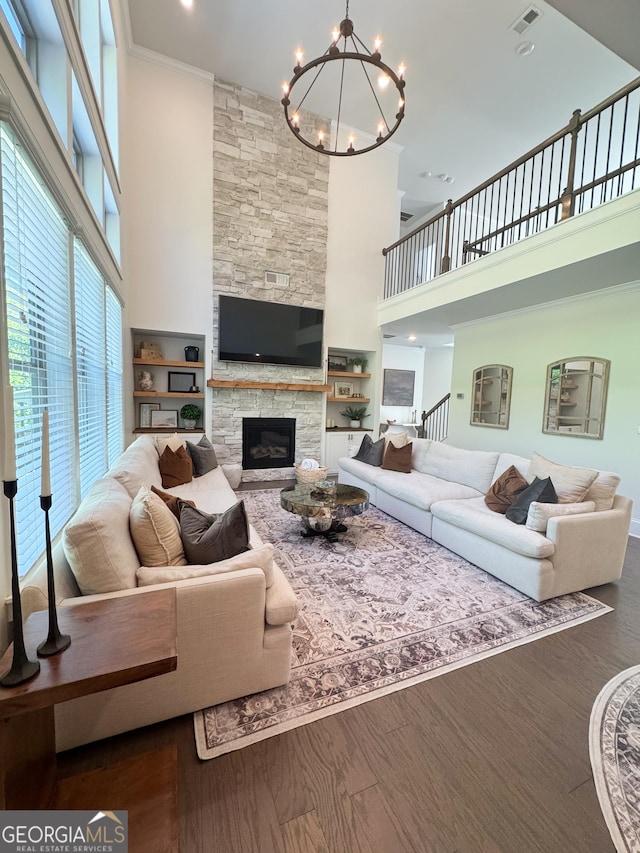 4736 Landing Water Path, Buford, GA 30519 - living area with a towering ceiling, a chandelier, a fireplace, ornamental molding, and wood finished floors