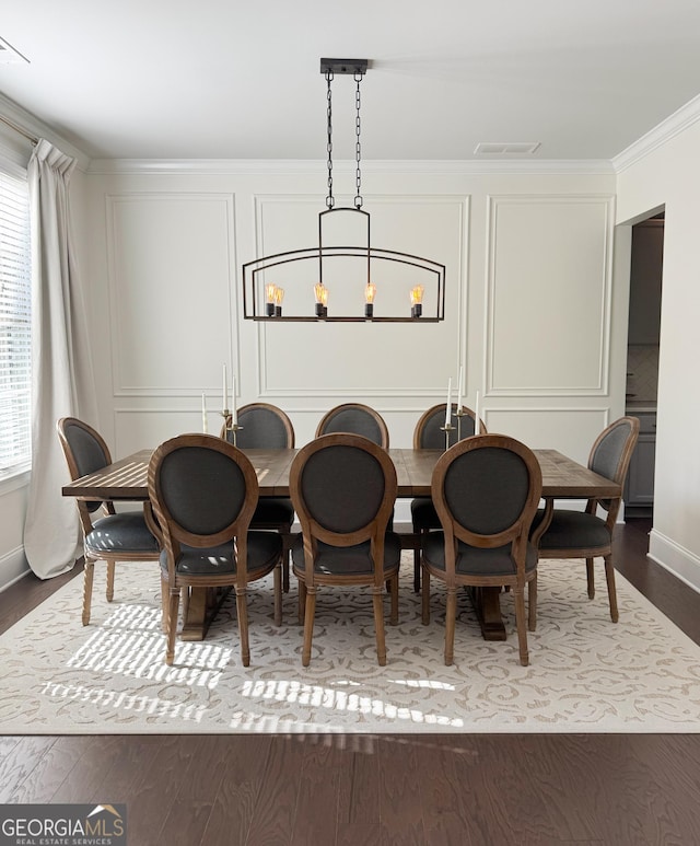 4736 Landing Water Path, Buford, GA 30519 - dining space with ornamental molding, a decorative wall, wood finished floors, and baseboards