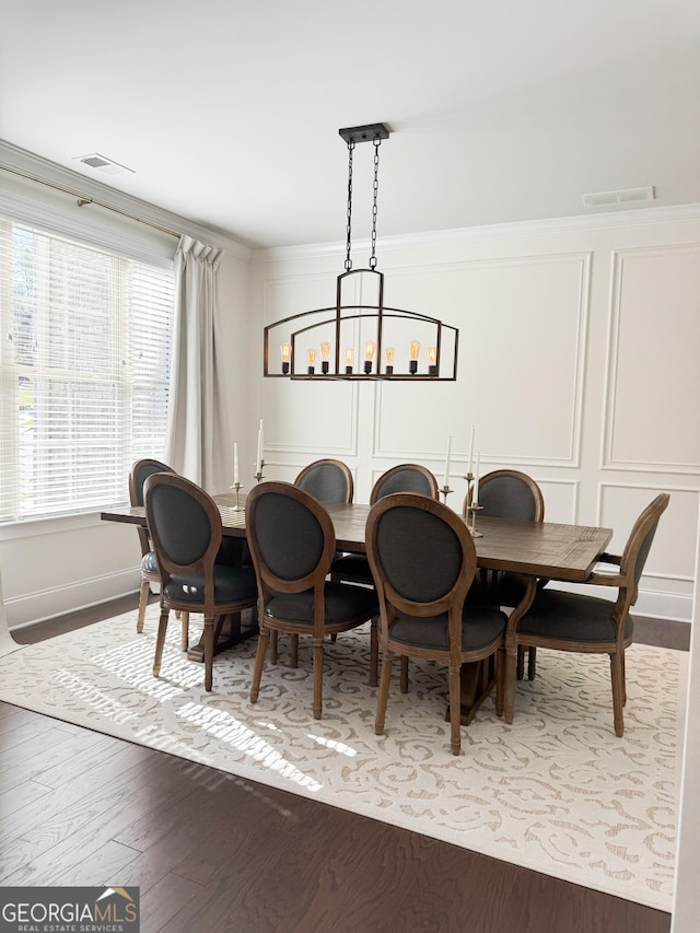 4736 Landing Water Path, Buford, GA 30519 - dining area featuring a chandelier, wood finished floors, a decorative wall, ornamental molding, and baseboards