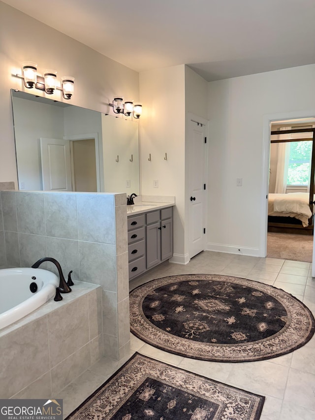4736 Landing Water Path, Buford, GA 30519 - ensuite bathroom featuring tile patterned flooring, vanity, a garden tub, and baseboards