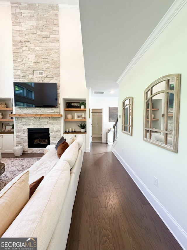 4736 Landing Water Path, Buford, GA 30519 - living area featuring a fireplace, baseboards, crown molding, dark wood-style flooring, and stairs
