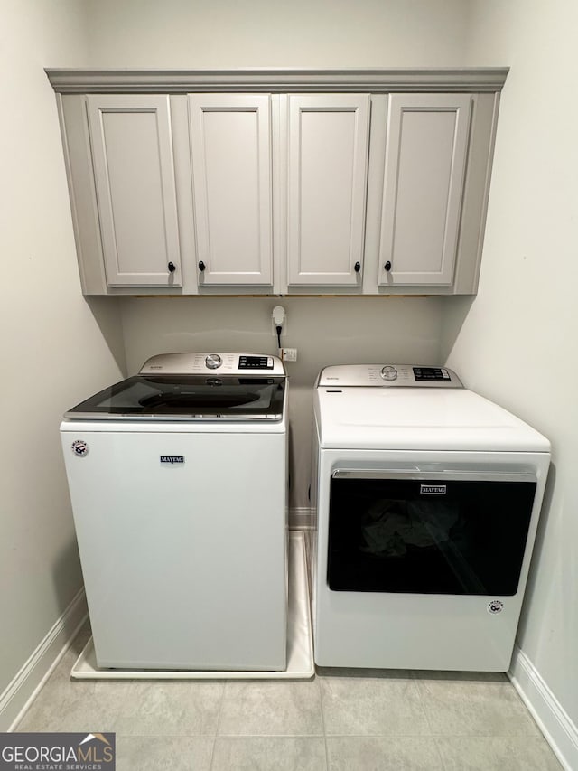 4736 Landing Water Path, Buford, GA 30519 - washroom featuring washing machine and clothes dryer, cabinet space, and baseboards