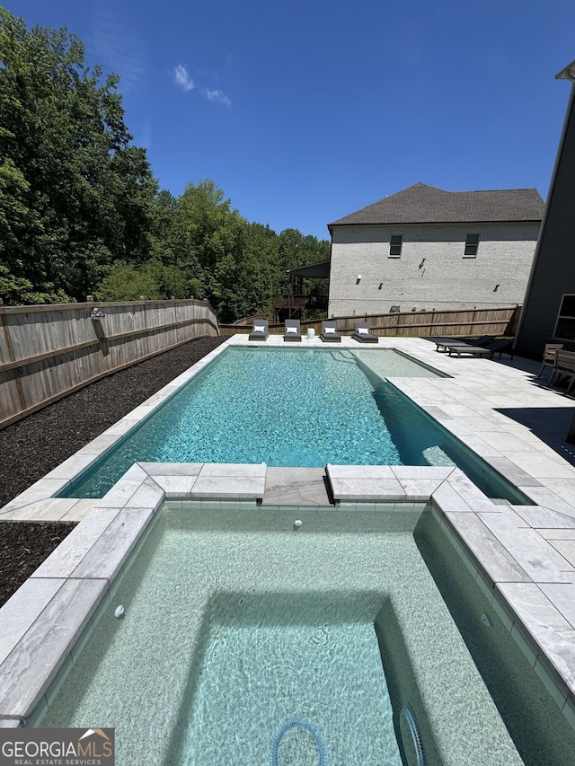 4736 Landing Water Path, Buford, GA 30519 - view of pool with a pool with connected hot tub, a patio area, and a fenced backyard