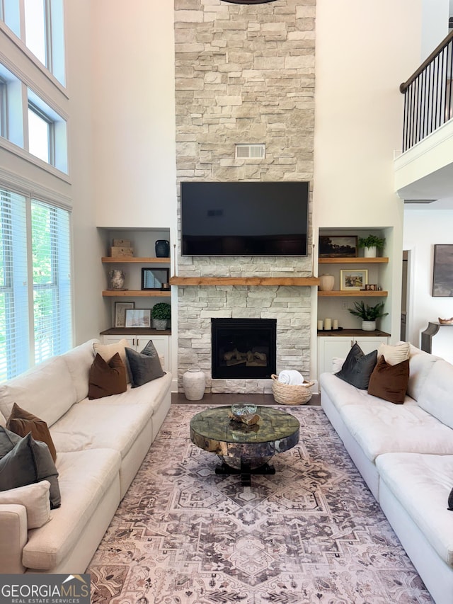 4736 Landing Water Path, Buford, GA 30519 - living area with a high ceiling, a stone fireplace, and built in shelves