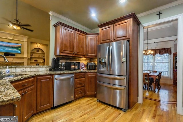87 Marcus Ct, Ball Ground, GA 30107 - kitchen featuring appliances with stainless steel finishes, light wood-type flooring, light stone counters, a ceiling fan, and ornamental molding