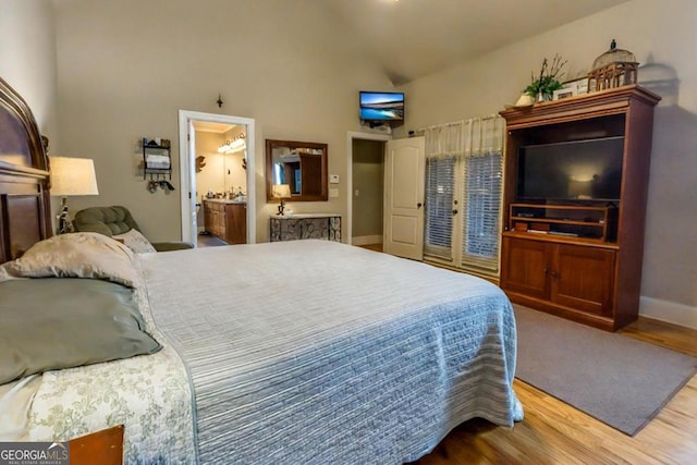 87 Marcus Ct, Ball Ground, GA 30107 - bedroom featuring wood finished floors, high vaulted ceiling, and connected bathroom