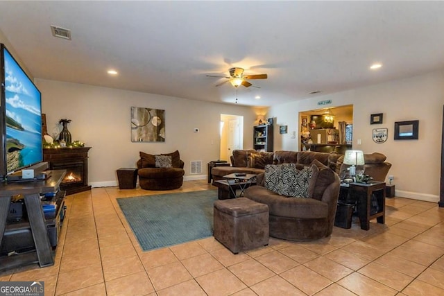 87 Marcus Ct, Ball Ground, GA 30107 - living room with light tile patterned flooring, ceiling fan, recessed lighting, and a lit fireplace