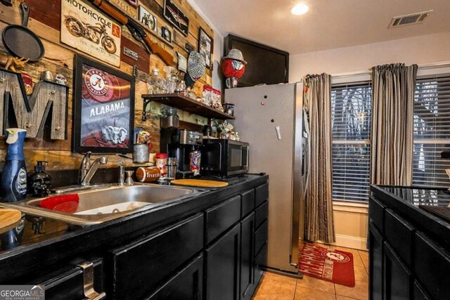 87 Marcus Ct, Ball Ground, GA 30107 - kitchen with dark cabinets, light tile patterned flooring, dark countertops, and refrigerator with ice dispenser