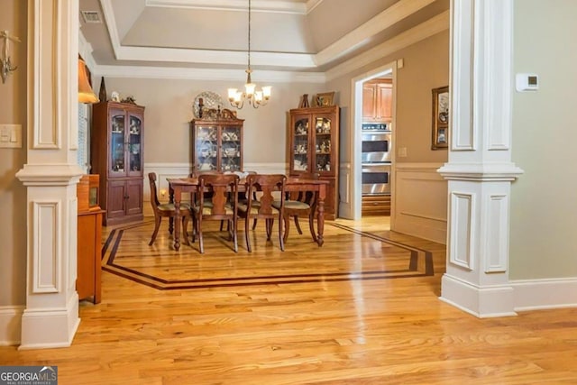 87 Marcus Ct, Ball Ground, GA 30107 - dining area with decorative columns, light wood-style flooring, ornamental molding, and a chandelier
