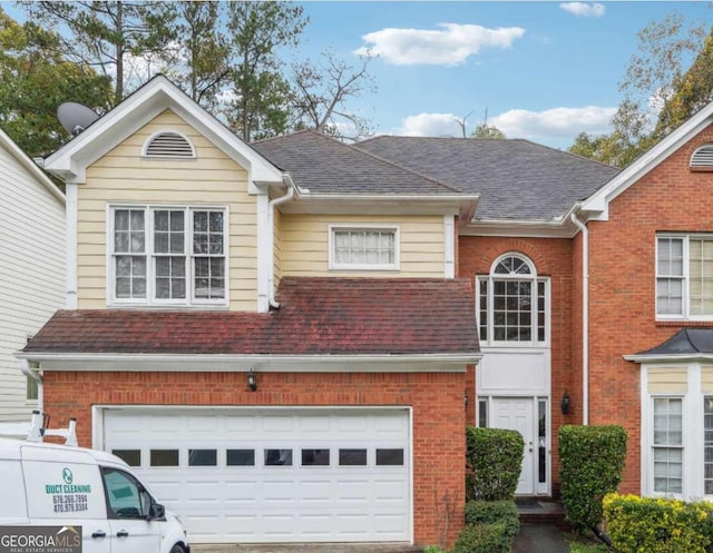 view of front facade featuring brick siding, roof with shingles, and an attached garage