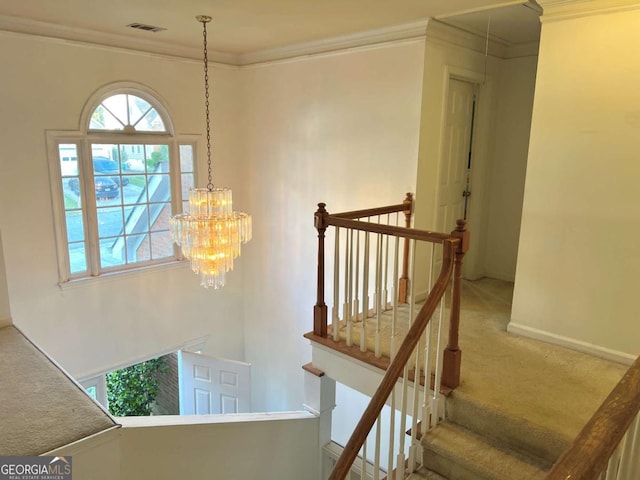 stairs with carpet flooring, crown molding, a chandelier, and baseboards