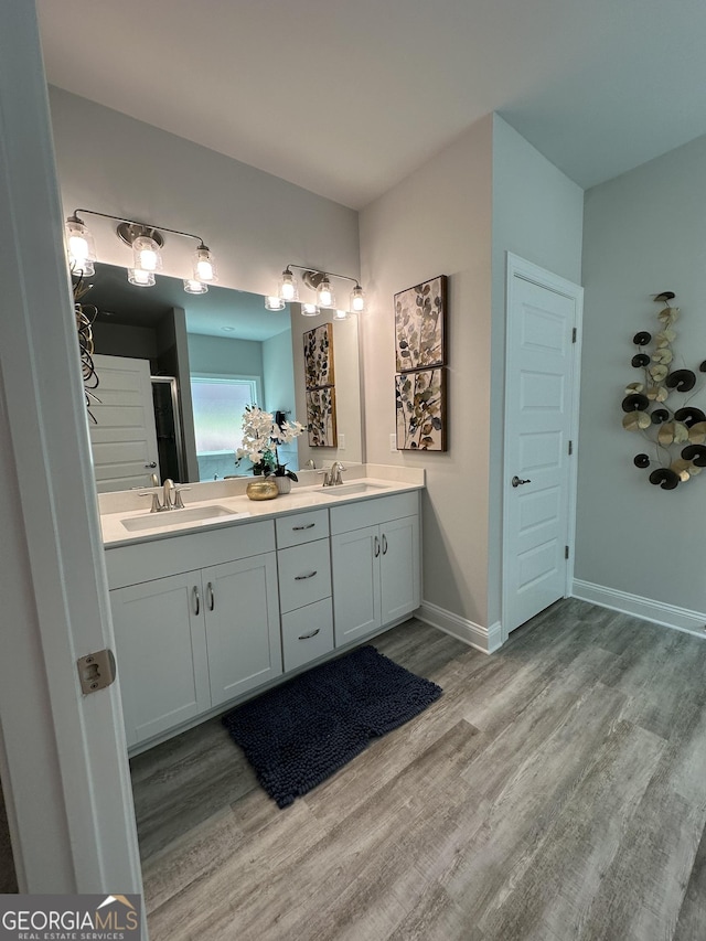 3006 Fairway Dr, Villa Rica, GA 30180 - full bath featuring wood finished floors, double vanity, and a shower