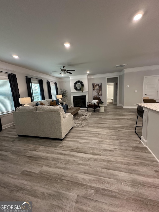 3006 Fairway Dr, Villa Rica, GA 30180 - living room featuring crown molding, a fireplace, ceiling fan, recessed lighting, and wood finished floors