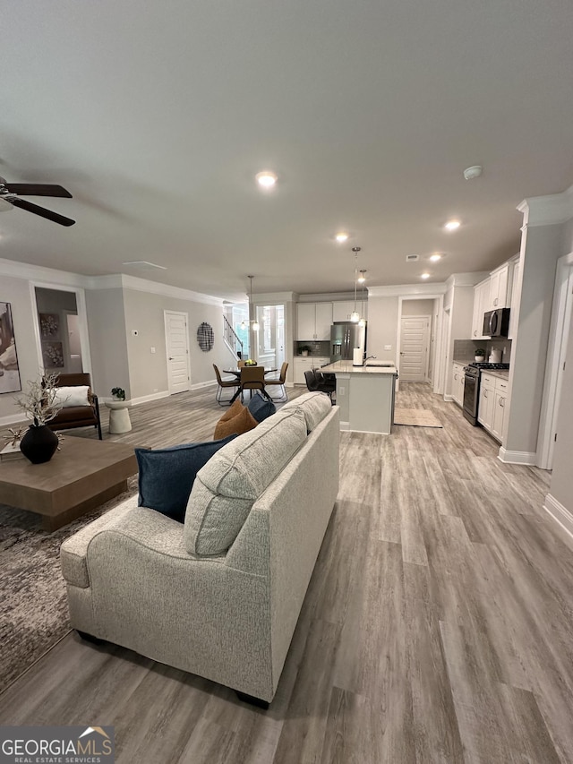 3006 Fairway Dr, Villa Rica, GA 30180 - living area featuring ornamental molding, light wood-style flooring, a ceiling fan, and recessed lighting