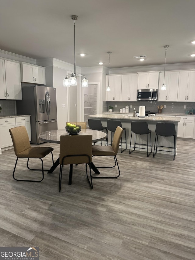 3006 Fairway Dr, Villa Rica, GA 30180 - dining area featuring wood finished floors, recessed lighting, and crown molding
