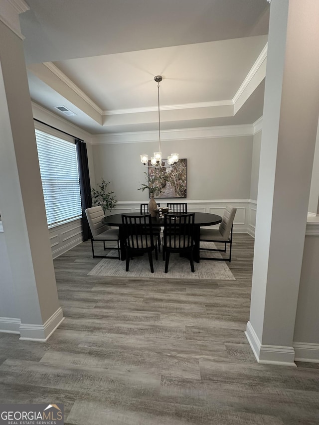 3006 Fairway Dr, Villa Rica, GA 30180 - dining room with a raised ceiling, a chandelier, wood finished floors, crown molding, and a wainscoted wall