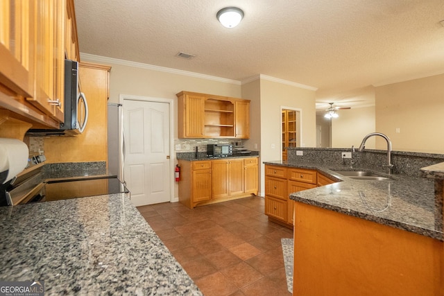 kitchen with a sink, appliances with stainless steel finishes, open shelves, crown molding, and a textured ceiling