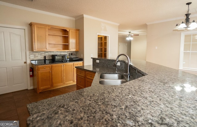 kitchen with a sink, open shelves, tasteful backsplash, dark tile patterned flooring, and a ceiling fan