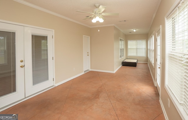 unfurnished sunroom featuring french doors, crown molding, baseboards, and a textured ceiling