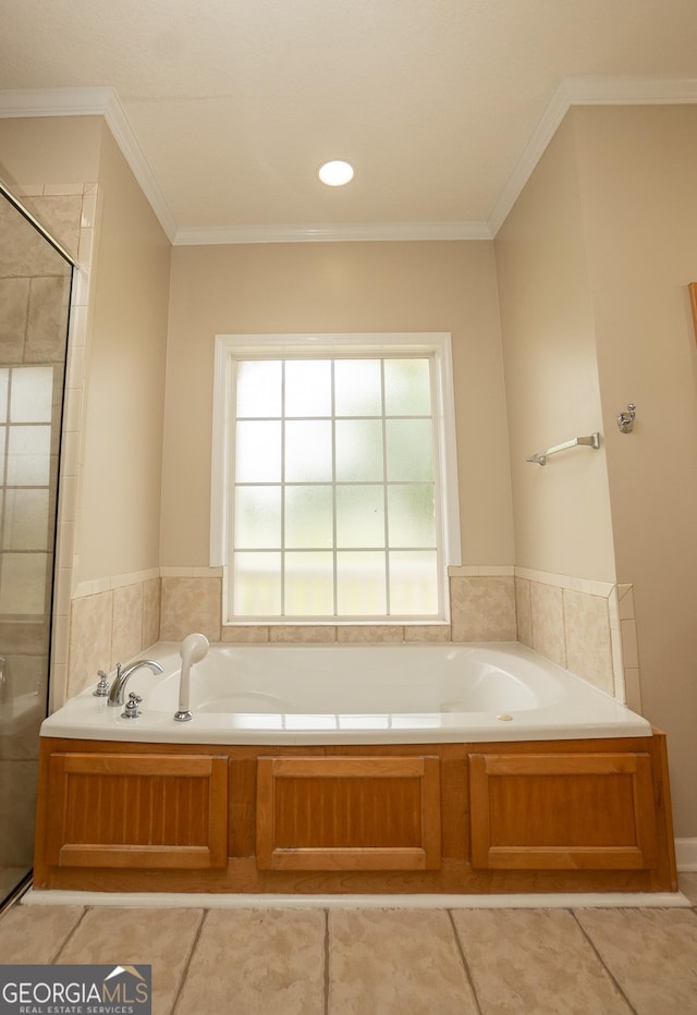 bathroom featuring a garden tub, a stall shower, crown molding, and tile patterned floors