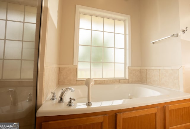full bathroom featuring a garden tub and a shower