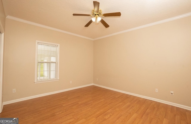 spare room featuring light wood finished floors, crown molding, a ceiling fan, baseboards, and a textured ceiling