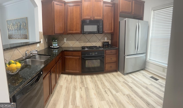 4540 Cold Spring Ct, Cumming, GA 30041 - kitchen featuring black appliances, a sink, dark stone countertops, light wood-type flooring, and decorative backsplash