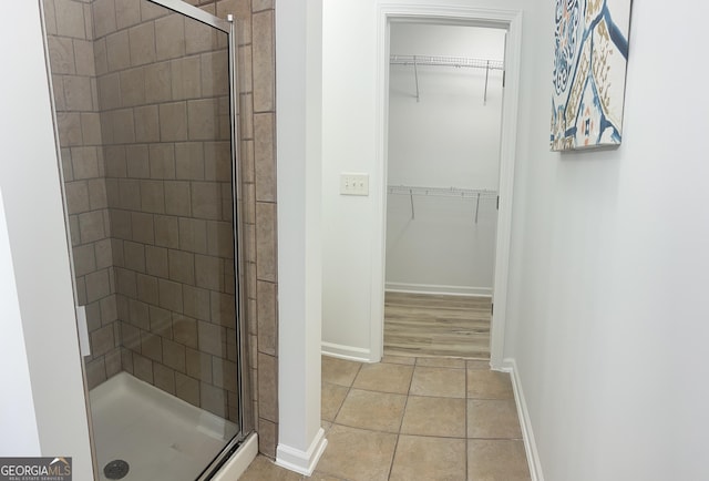 4540 Cold Spring Ct, Cumming, GA 30041 - full bath with a stall shower, baseboards, tile patterned floors, and a walk in closet