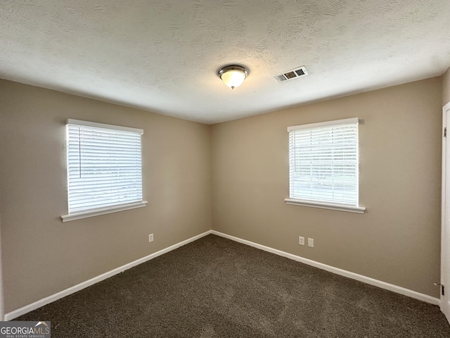 6309 Wellington Way, Austell, GA 30106 - unfurnished room with dark colored carpet, baseboards, and a textured ceiling