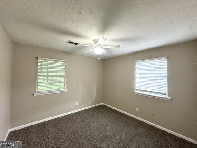 6309 Wellington Way, Austell, GA 30106 - unfurnished room with ceiling fan, baseboards, dark colored carpet, and a textured ceiling