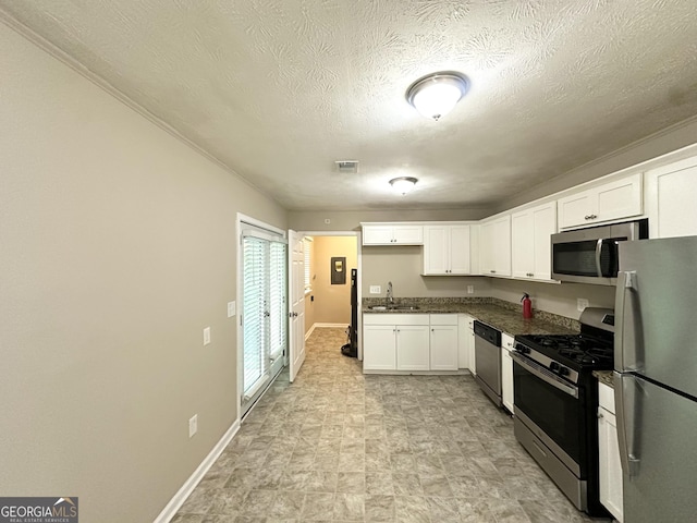 6309 Wellington Way, Austell, GA 30106 - kitchen with stainless steel appliances, a sink, dark countertops, white cabinets, and baseboards