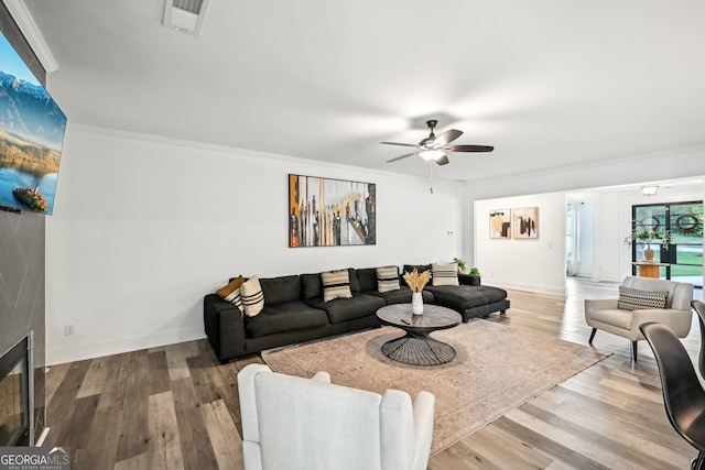 3991 Perry Pass, Lithonia, GA 30038 - living room featuring wood finished floors, a ceiling fan, crown molding, and baseboards